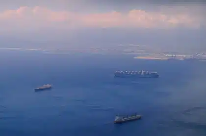 Cargo ship with fire and smoke on the Black Sea during military conflict