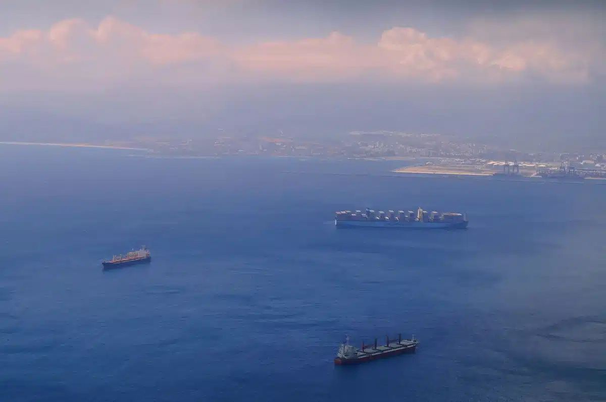 Cargo ship with fire and smoke on the Black Sea during military conflict